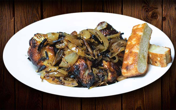 Wood-fired wings with caramelized onions